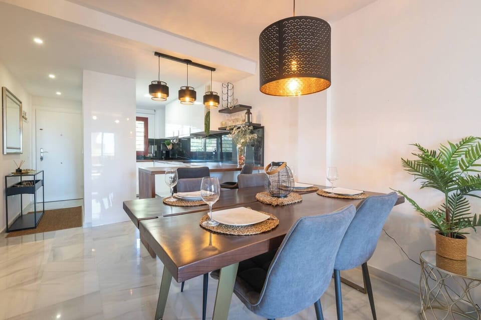 Living/dining room with table for four and a comfortable L-shaped sofa with Smart Tv and AC (2)