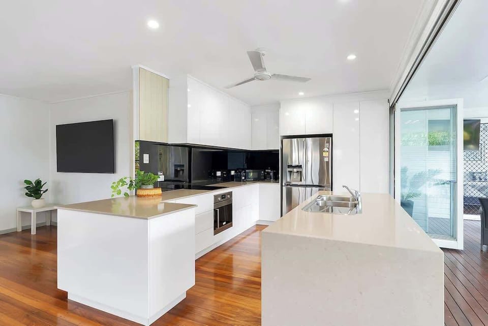The modern kitchen is equipped with everything you need to whip up a meal at home, including a fridge, oven, stove, microwave and dishwasher.