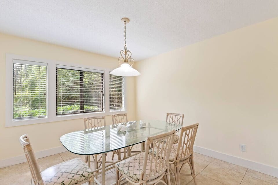 Comfortable dining area seating six with easy access to the kitchen, living room, and patio.