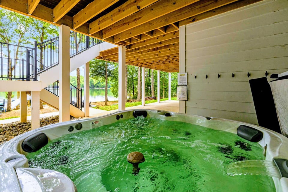 Hot Tub - A bubbling hot tub tucked under the deck, lake views out the open side after a day on the water.