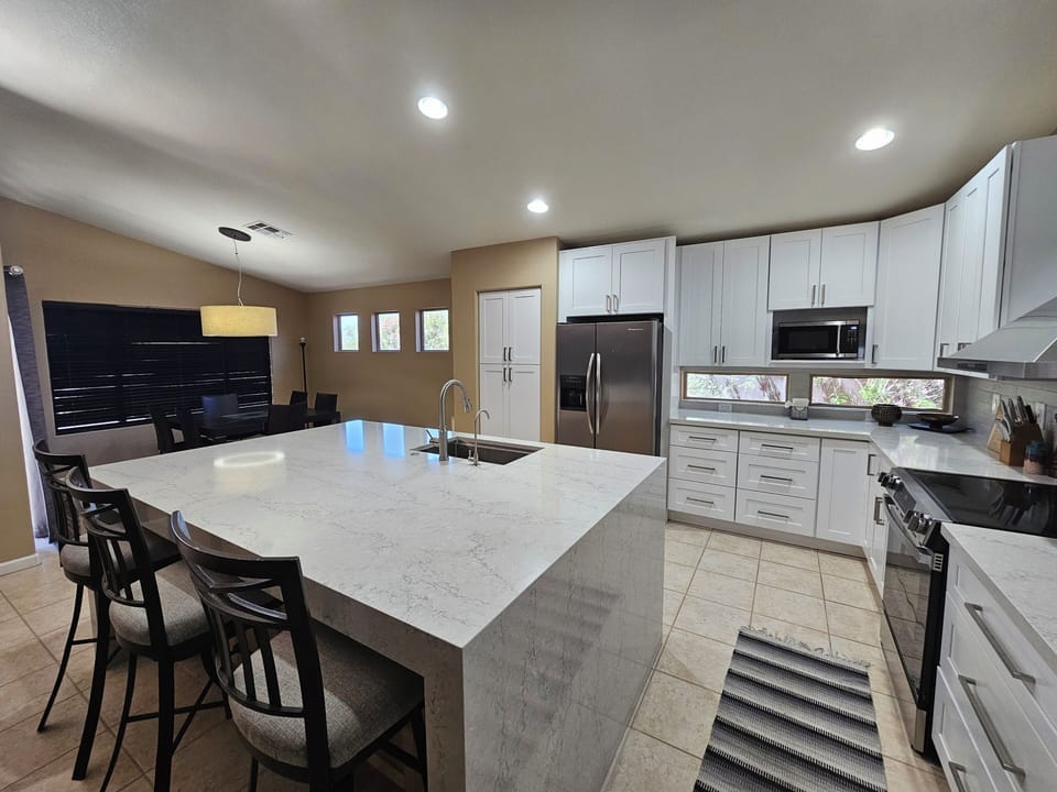 Large kitchen island with 6 person dining table