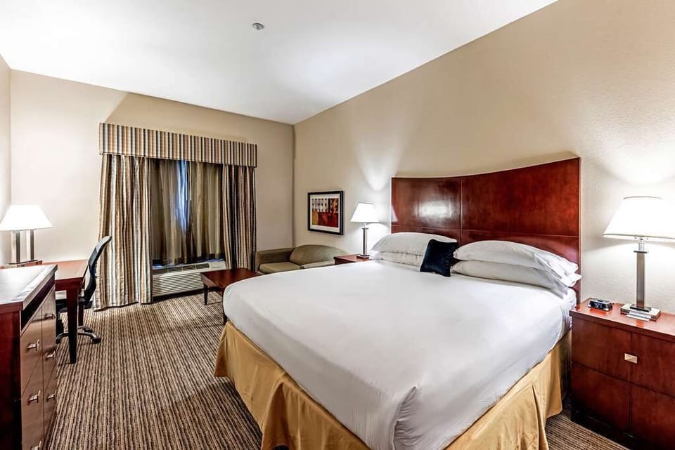 Sink into a king bed with warm, calming lighting.