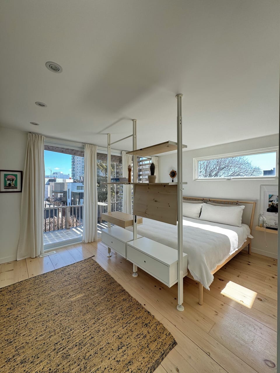Master bedroom with king-sized bed, balcony, and wall-to-wall closets