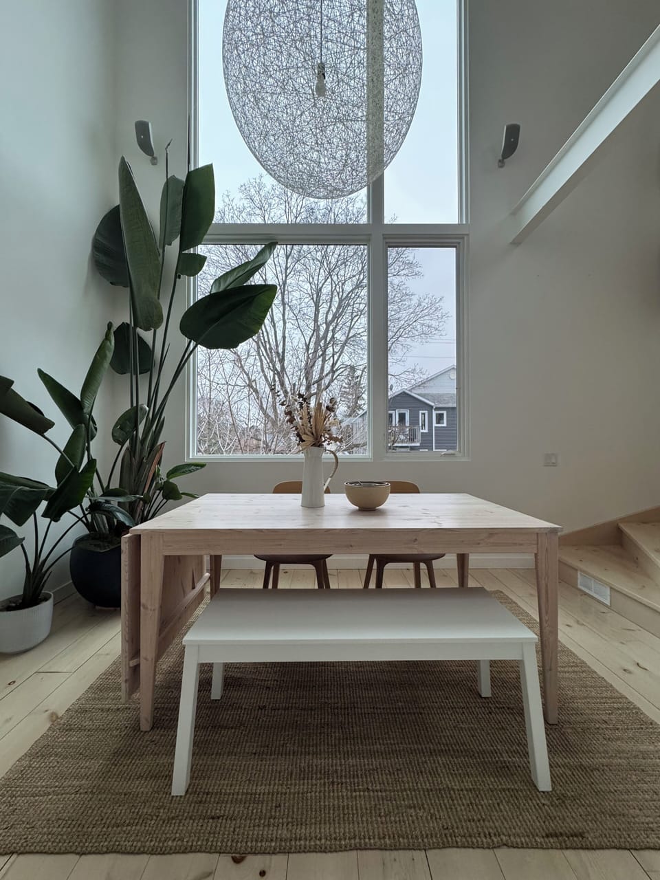 Dining room with 18 foot ceilings and picture window looking onto Hintonburg