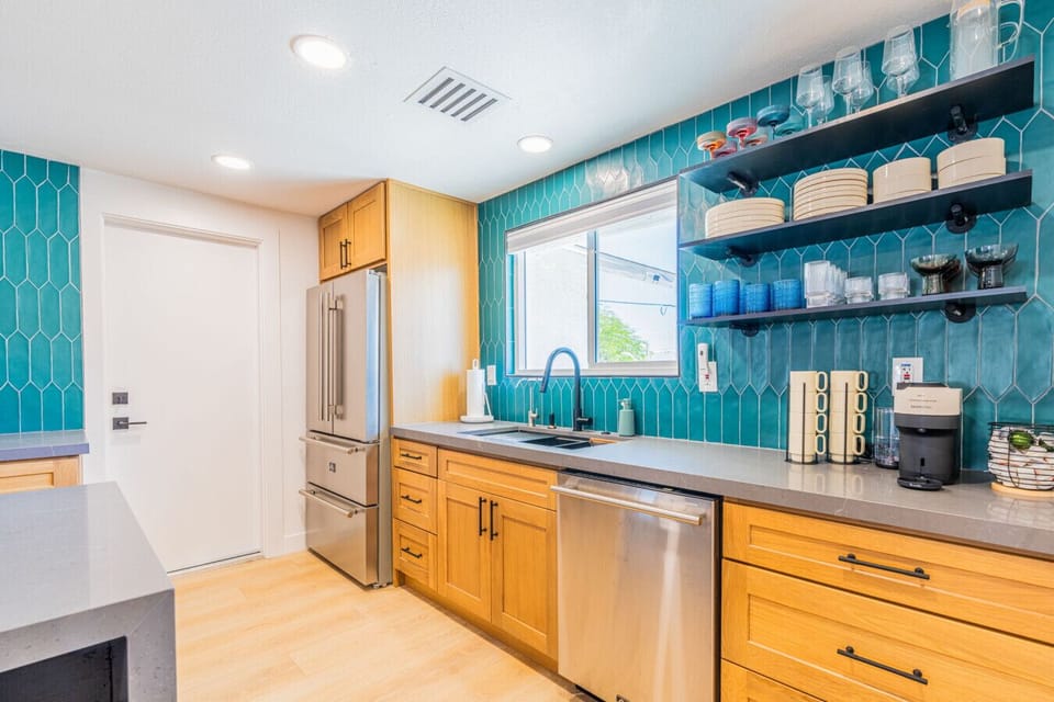 Stylish kitchen w/ warm wood cabinets, tile backsplash, & plenty of prep space for home-cooked meals.