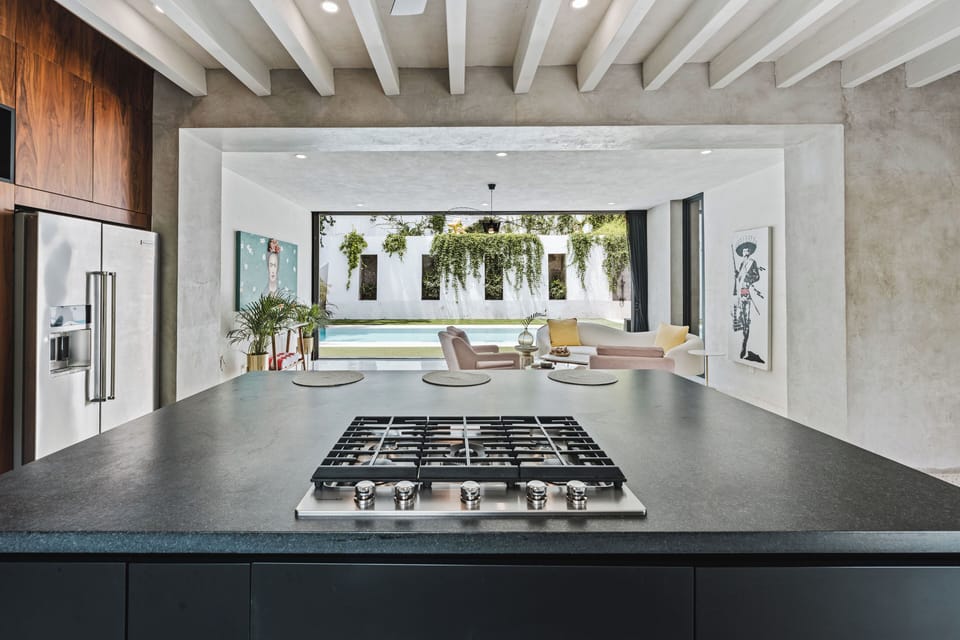 Floor to ceiling glass doors open for true indoor/outdoor living