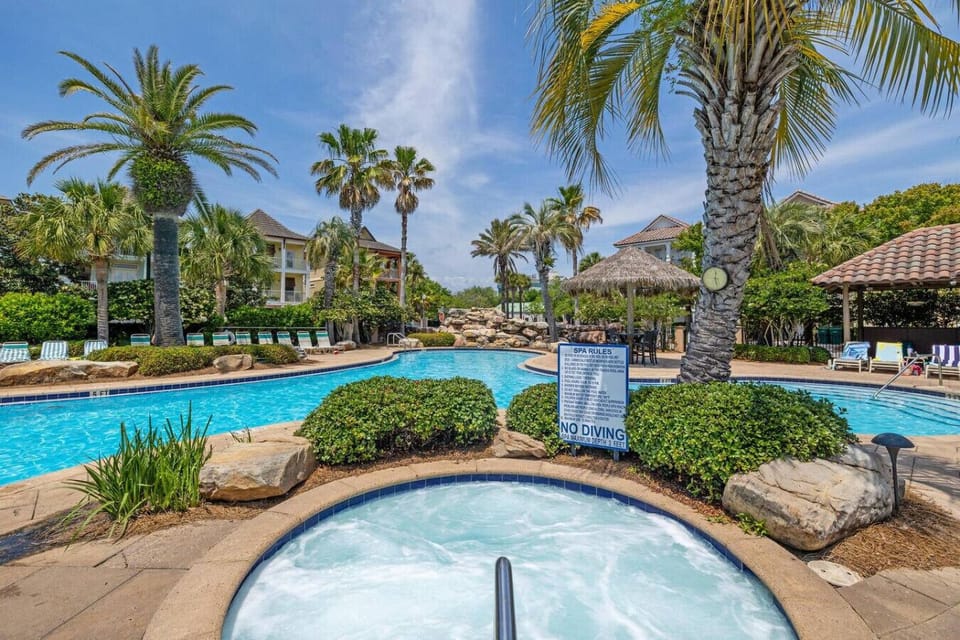 Spa day vibes with that hot tub ready to melt away your stress while palm trees sway overhead like they`re on vacation too.