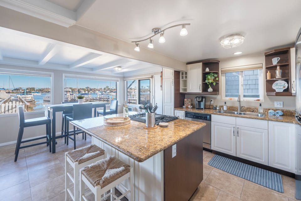 A modern kitchen with granite countertops and ample space for cooking. (Unit B)