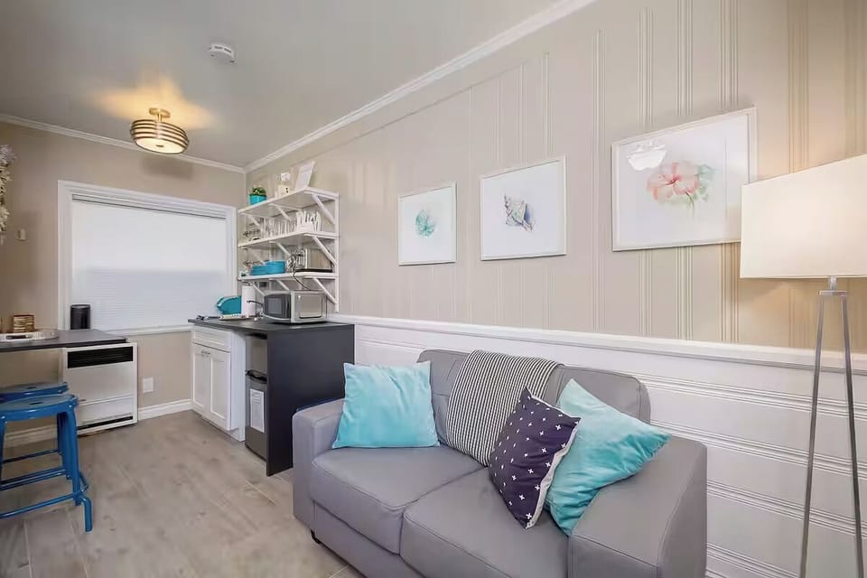 A stylish living area with soft cushions and charming wall art. (Edgewater C)