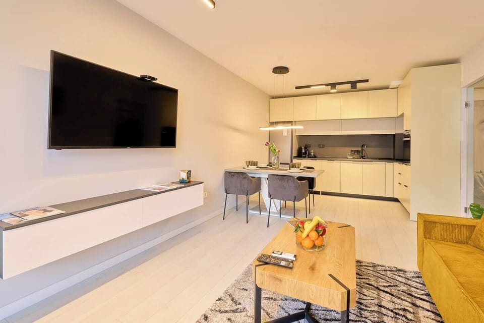 Unwind in a bright, open living space with Smart TV and comfy seating. Curious about our entertainment options? Message us!