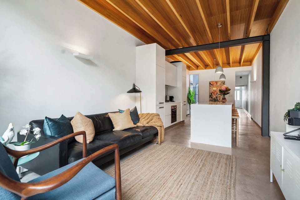 Unwind in the modern living area, complete with an indoor dining space and television.