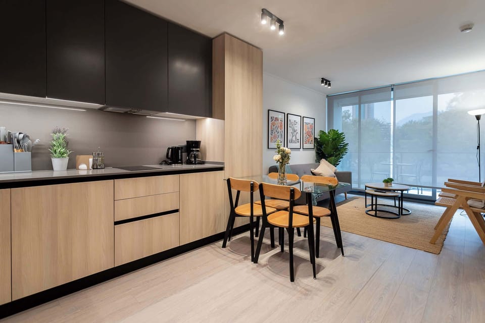 Stylish kitchen and dining area with a cozy living space, perfect for relaxing and enjoying meals.