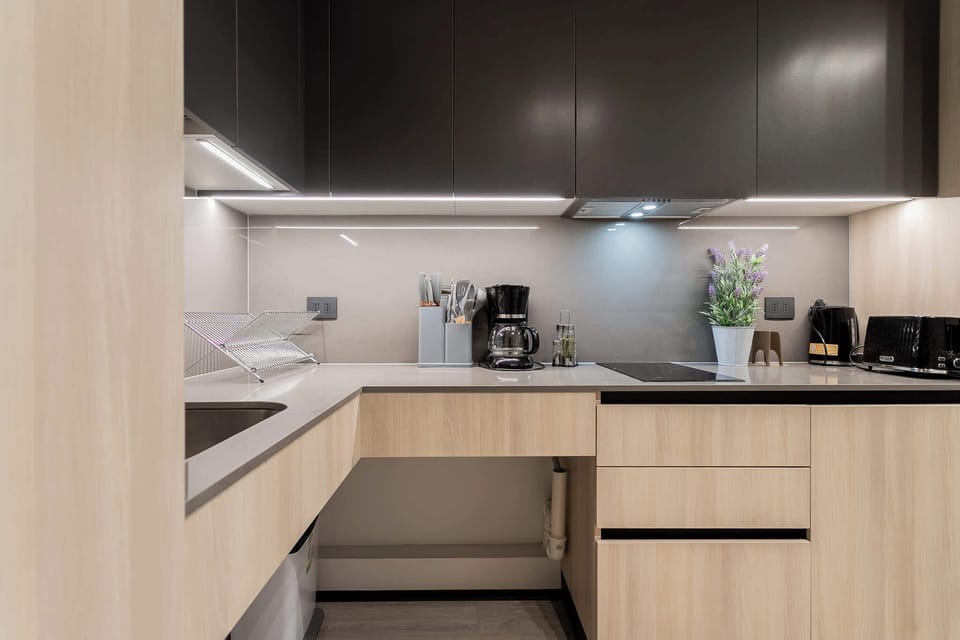 Modern kitchen with sleek appliances and under-cabinet lighting, perfect for culinary adventures.