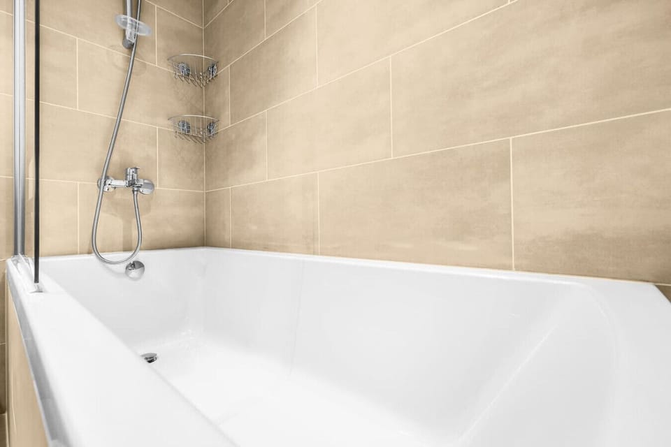 Luxurious Bathroom: Unwind in a sleek tub, perfect for a refreshing soak after a day of adventure!