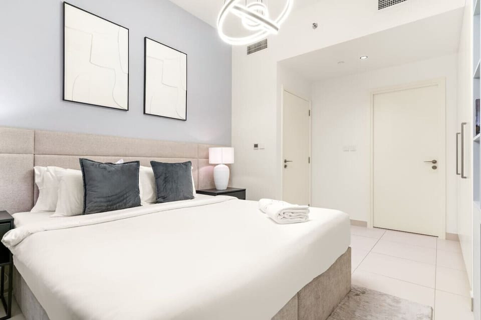 Bedroom Retreat: Experience modern elegance with plush linens and stylish decor!