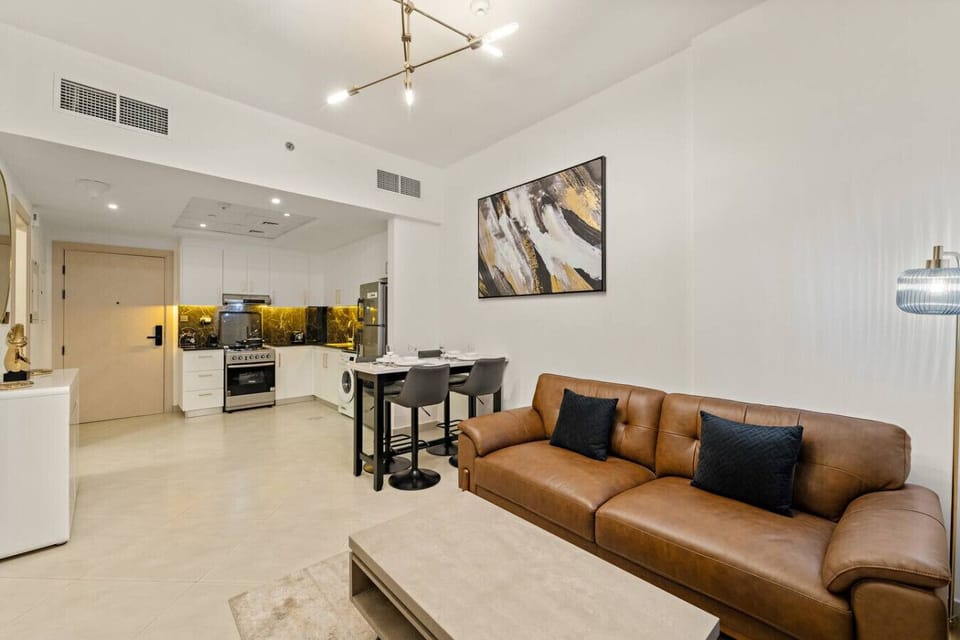 Living Room: Chic design with modern flair, comfy leather sofa, and sleek kitchen bar for gathering!