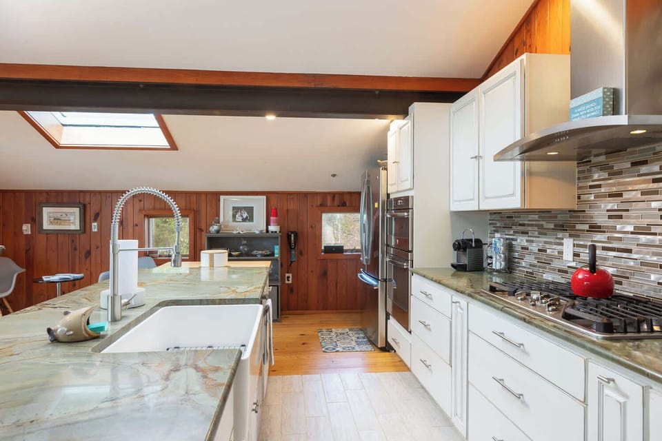Fully Equipped Kitchen with Refrigerator, Stove, Oven, Microwave,Dishwasher,Nespresso Tea Kettle, Generous Counter Space, Center Island, and Bar Seating, Perfect for Cooking and Socializing Together