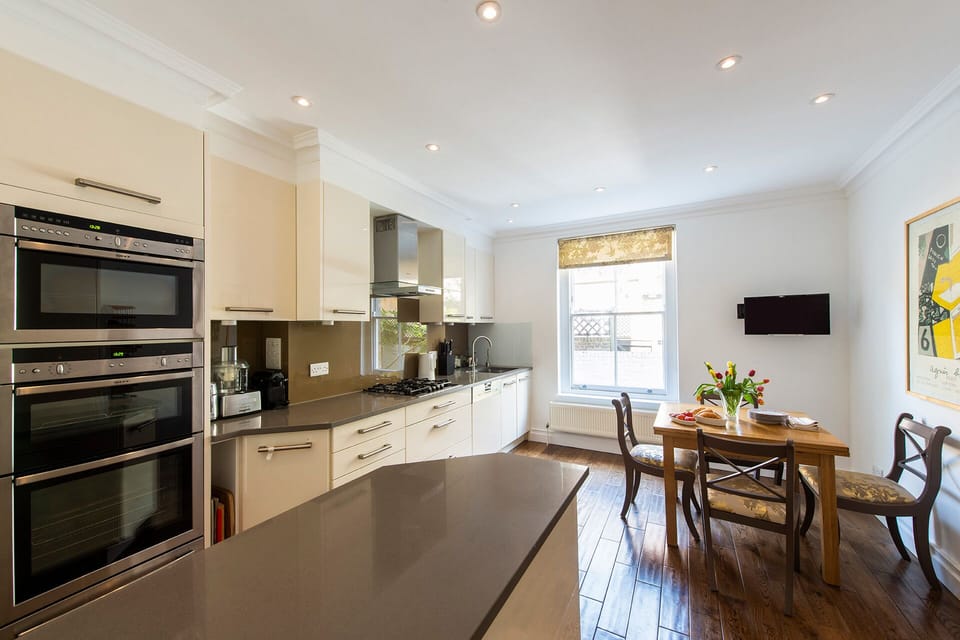 Gorgeous kitchen with large window and dining area.