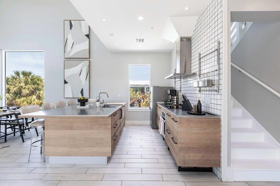 The kitchen is a chef's dream, equipped with top-of-the-line appliances and sleek countertops, making it perfect for entertaining.