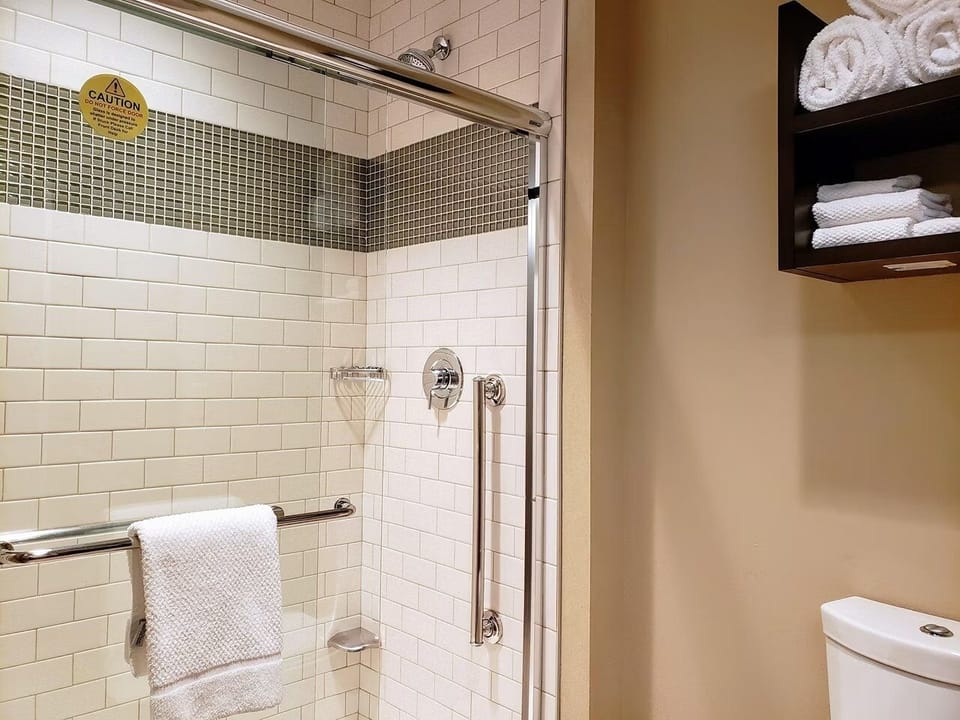Rinse off comfortably in a modern, accessible walk-in shower.