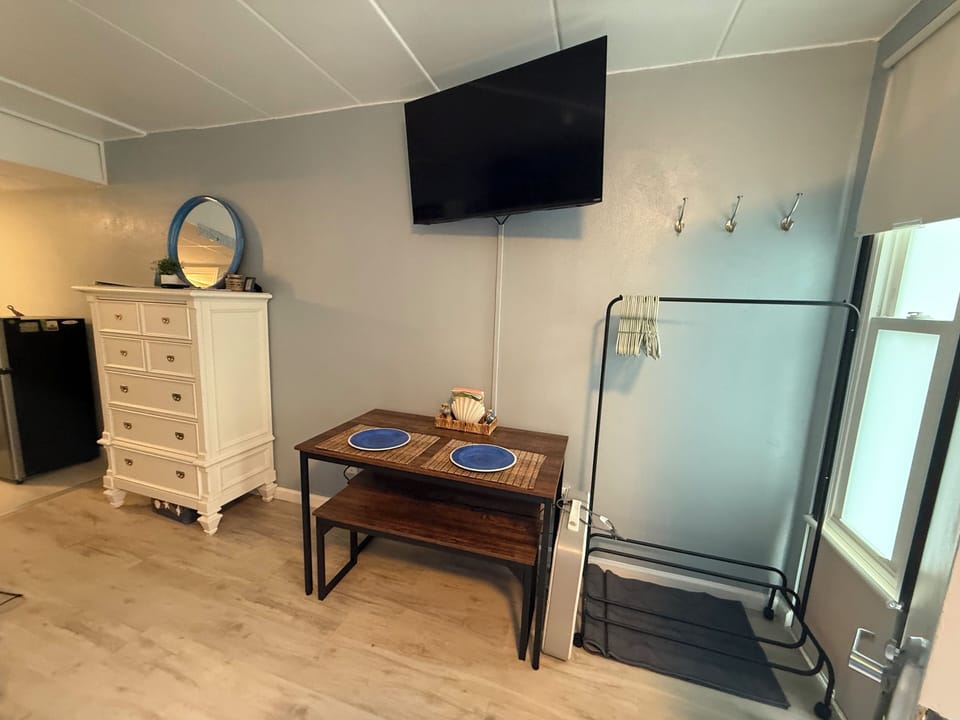 Seating for four, place to hang clothes, and 42in TV