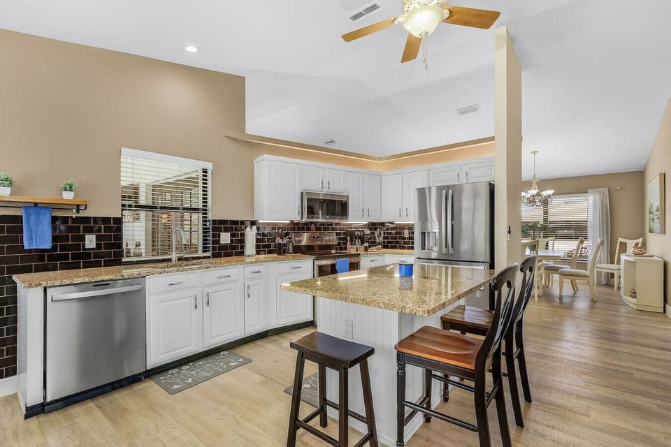 A modern clean kitchen - pull up a chair and chat with the chef