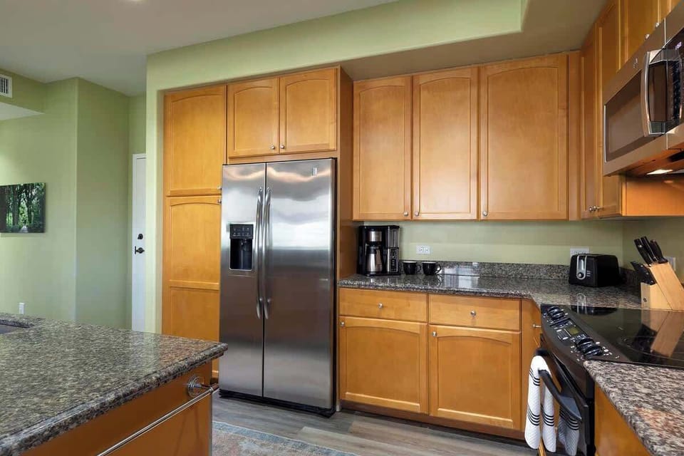 Cook in comfort with granite countertops, stainless appliances, wood cabinetry, and modern layout.

