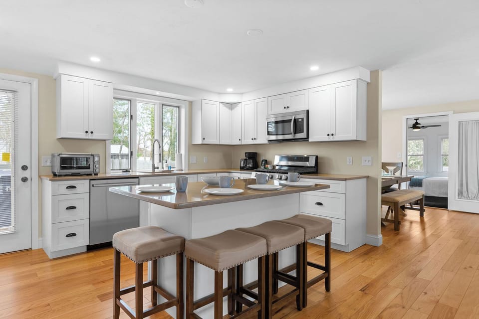 Updated and fully stocked kitchen with counting seating, drip coffee & coffee. 