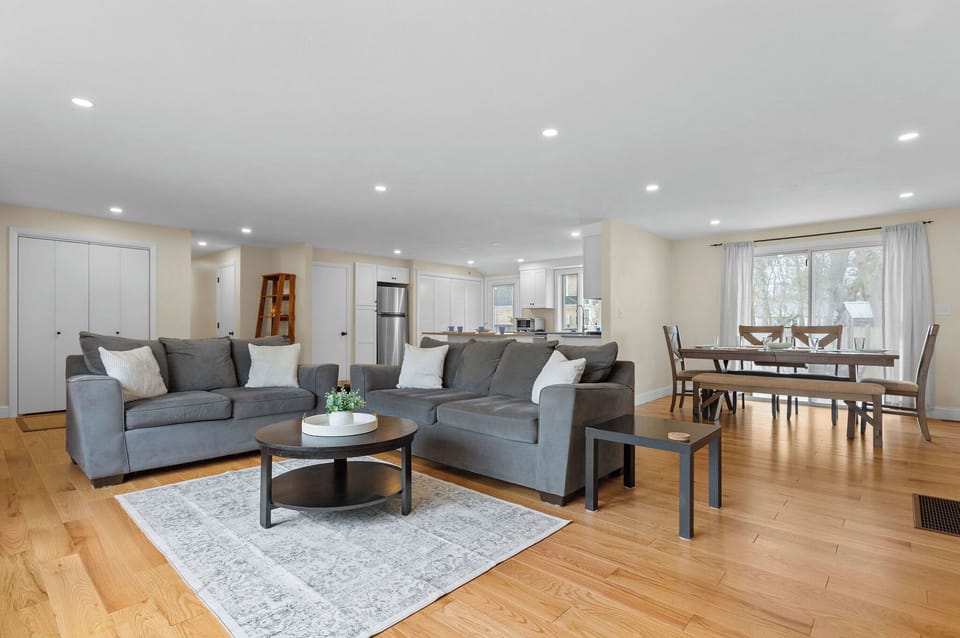 Open concept living! Living room with cozy couches and TV. 