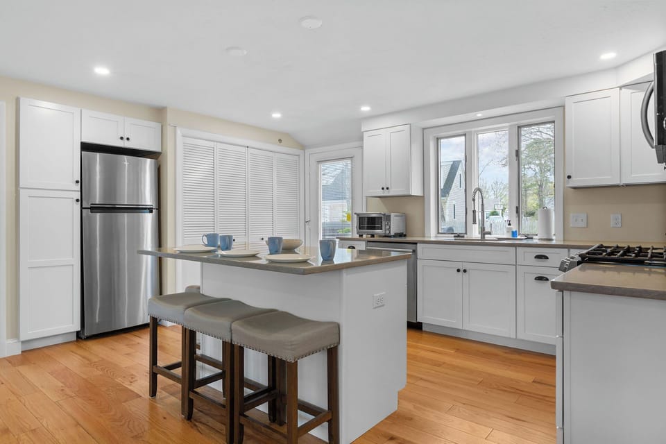 Updated and fully stocked kitchen with counting seating, drip coffee & coffee. 