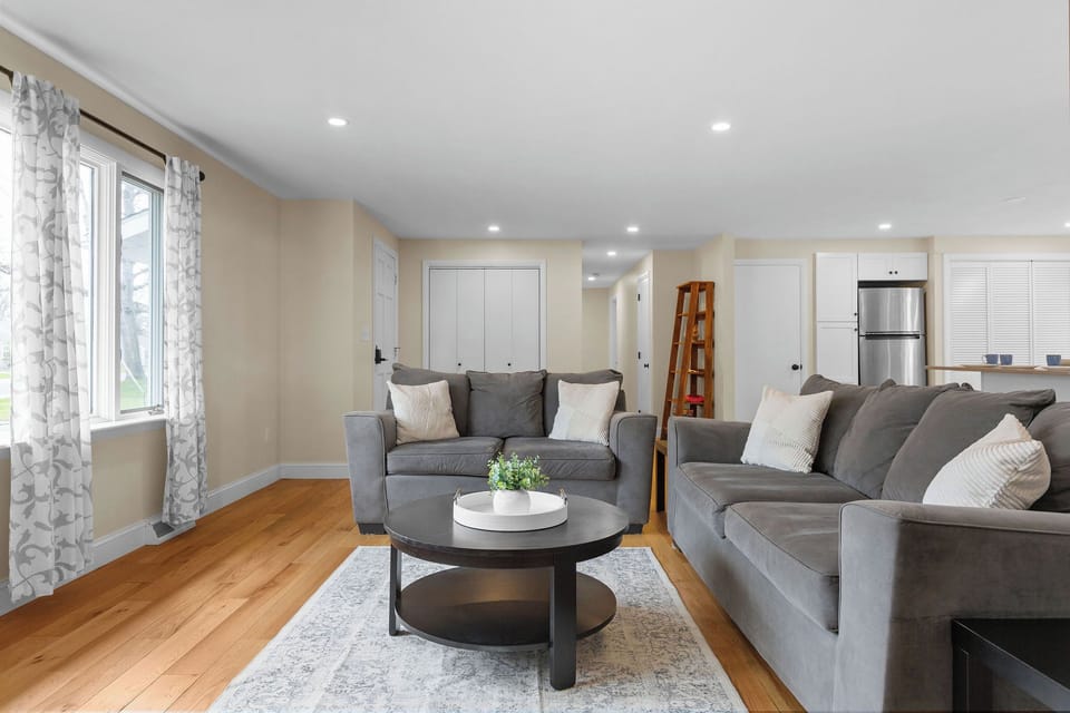Open concept living! Living room with cozy couches and TV. 