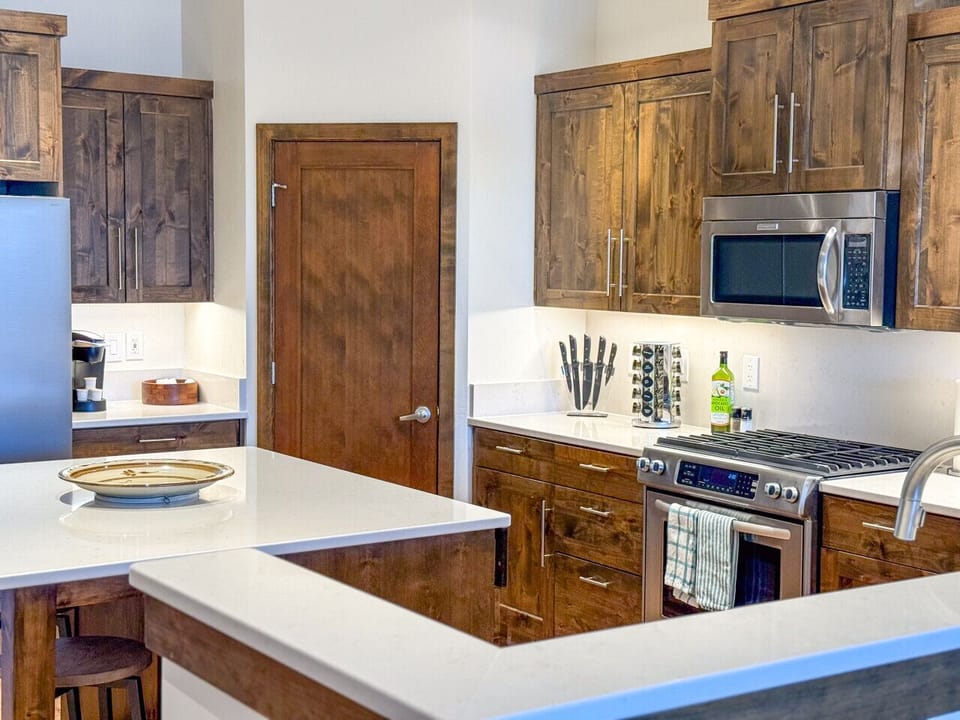 This beautifully designed space flows seamlessly from the chef-ready kitchen to the modern dining area—perfect for entertaining, family meals, or sharing stories after a day in Bend.