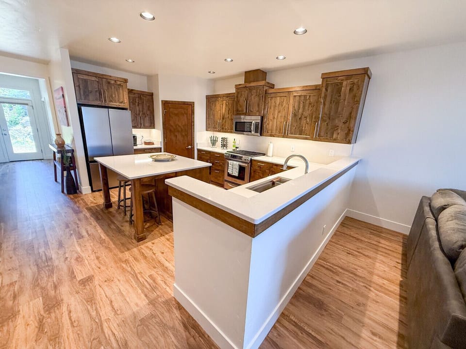 Gourmet kitchen with quartz island, high-end stainless appliances, and bright modern design — perfect for cooking and entertaining.