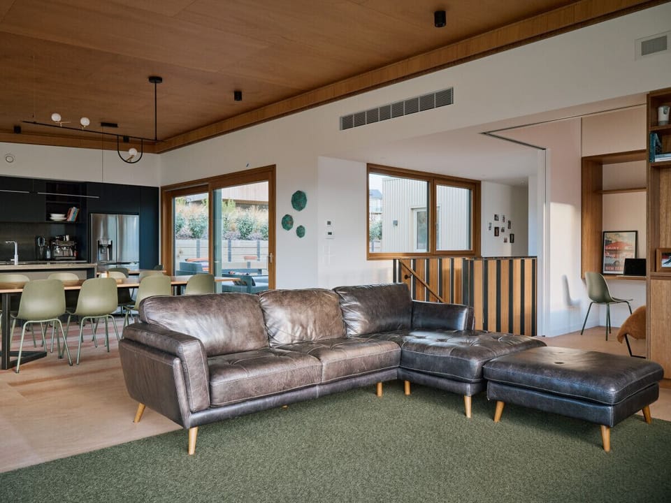 Open-plan living, dining, and kitchen area, with an adjoining bedroom