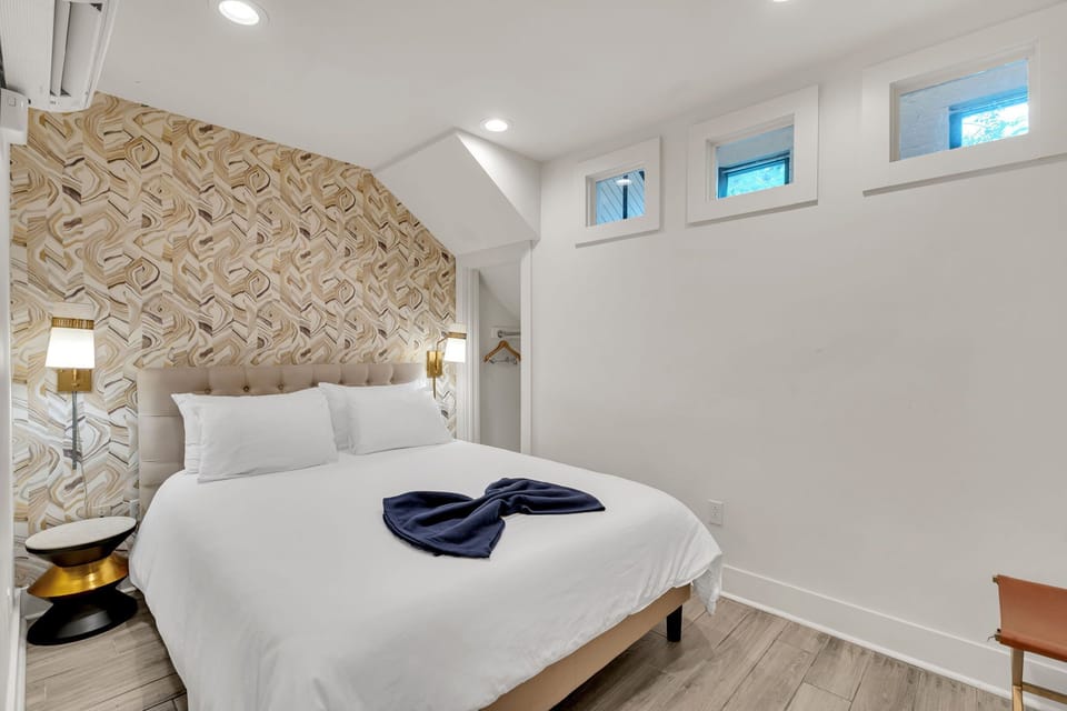 Peaceful sleeping space with bold accent wall and soft lighting.