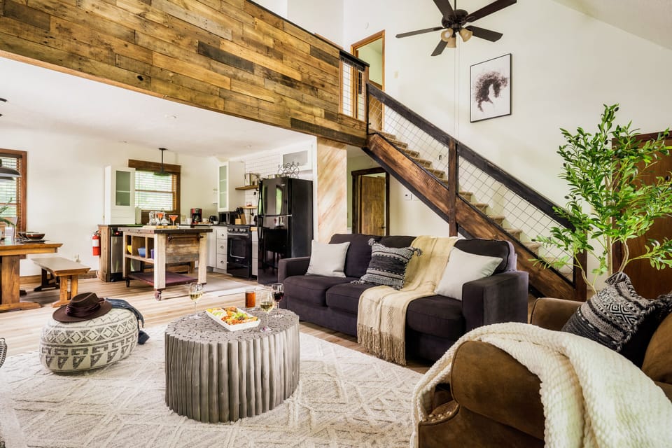 Cozy living room with greens and wood accents to bright up the space.
