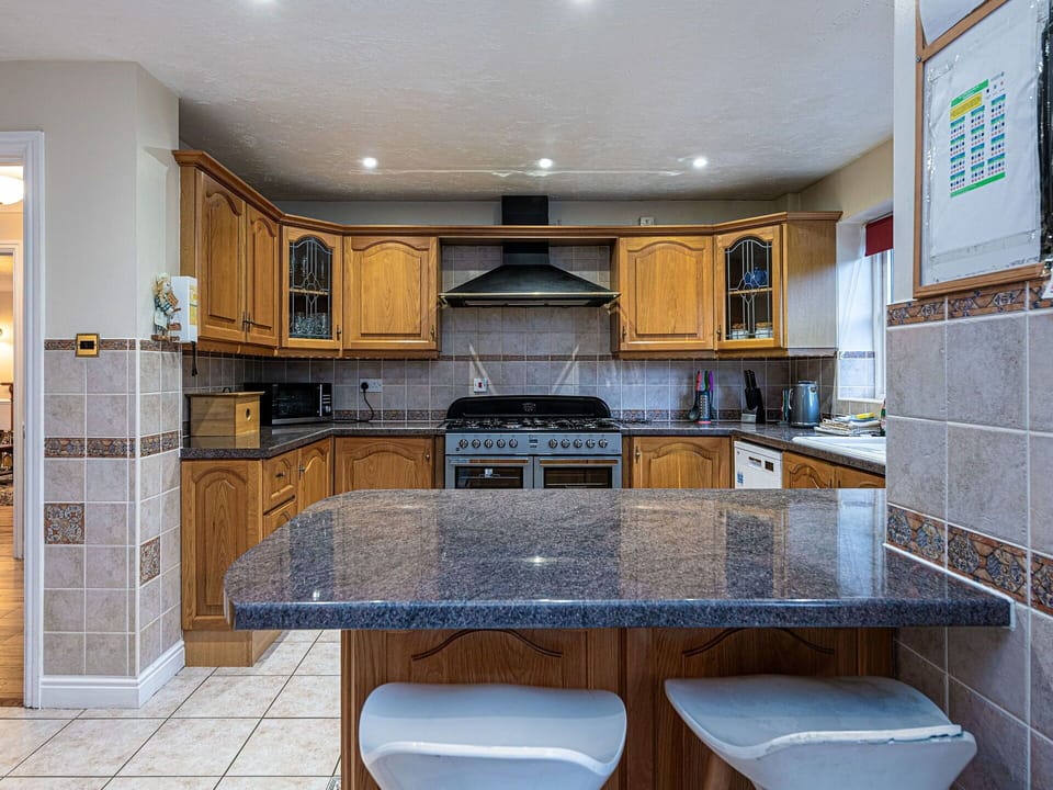 Kitchen, Countertop, Kitchen Appliance, Cabinetry, Flooring, Interior Design, Furniture, Wood, Floor, Major Appliance