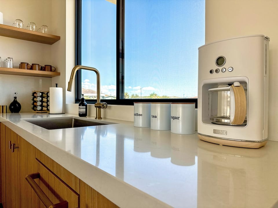 Coffee corner with drip maker and complimentary brews, teas and sweeteners