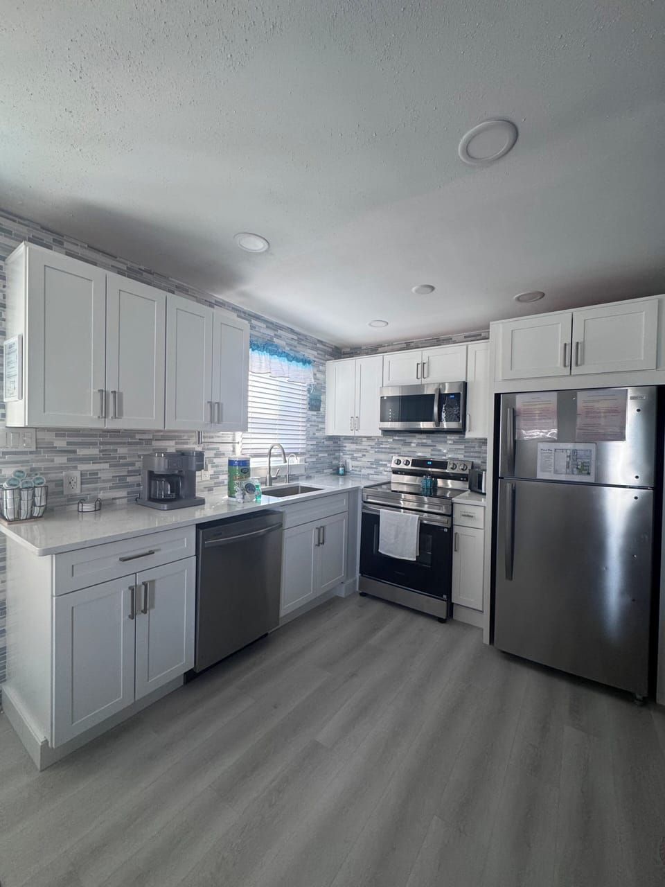 Newly renovated kitchen, with Dishwasher, oven, Microwave, Toaster, and Fridge
