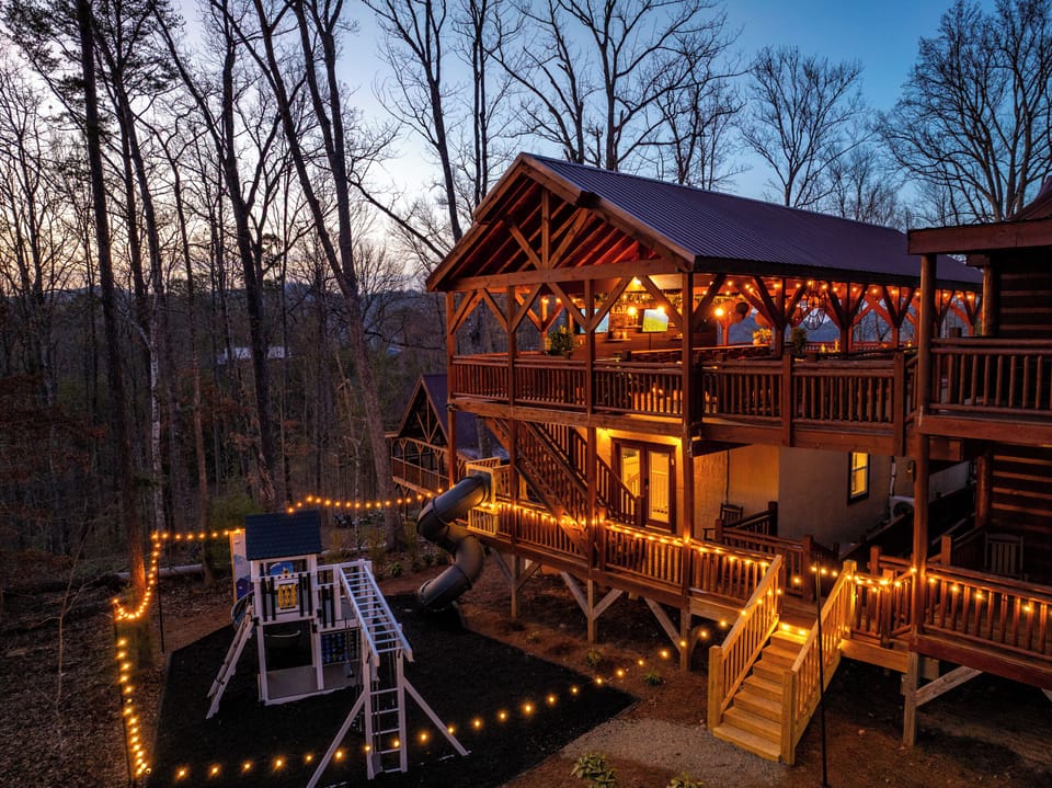 A heated indoor pool, hot tub, play ground, climbing walls, sports bar, oversized slide, and eating and lounging for 20…you and your guests will never want to leave the cabin!