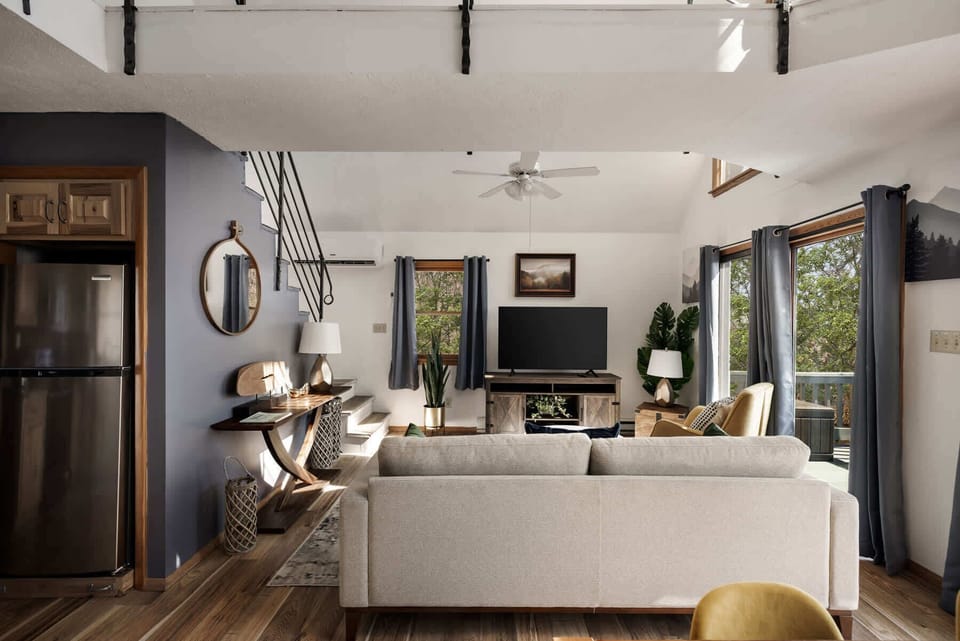 Modern living room with natural light and access to an outdoor deck.