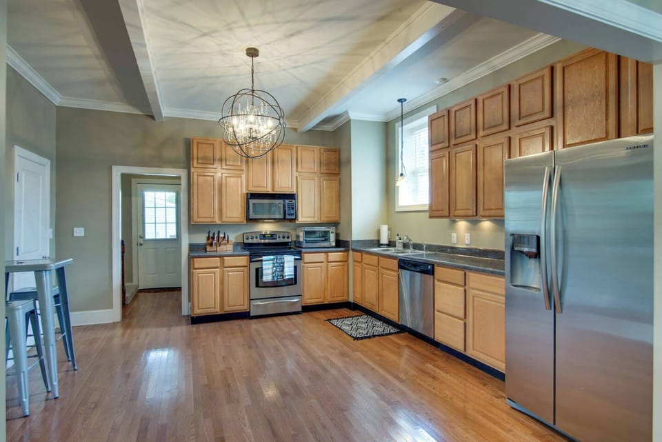 HUGE kitchen that looks into the dining room and living room with pub table and stools