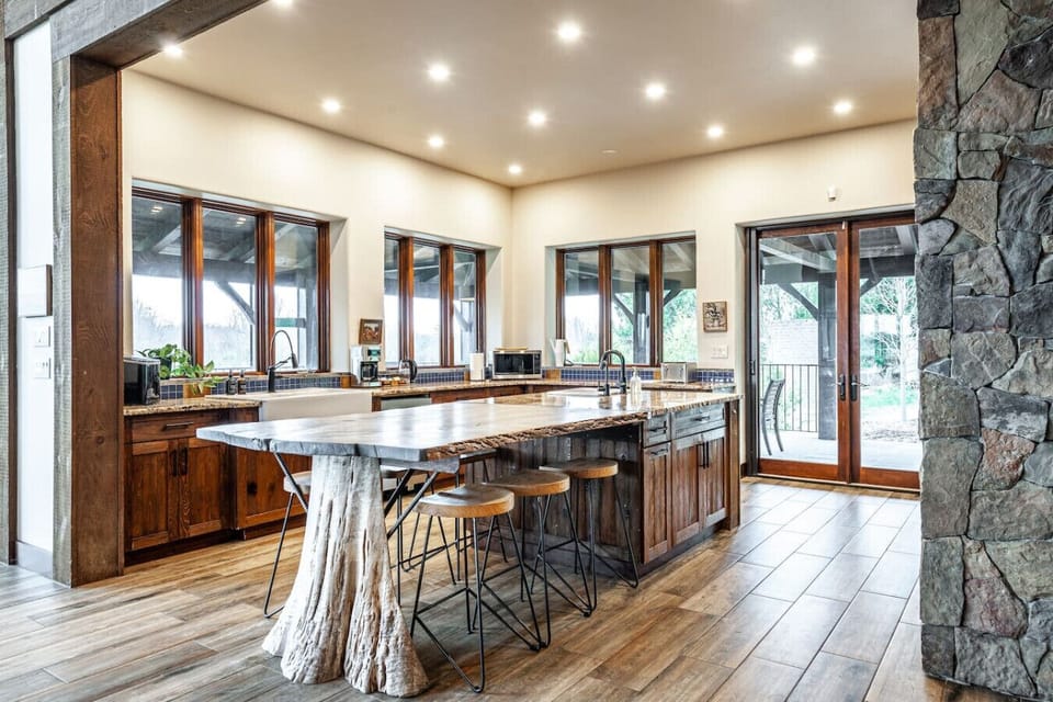 Fully equipped kitchen with large island, premium appliances, and seating for 20+ — great for group meals and events.