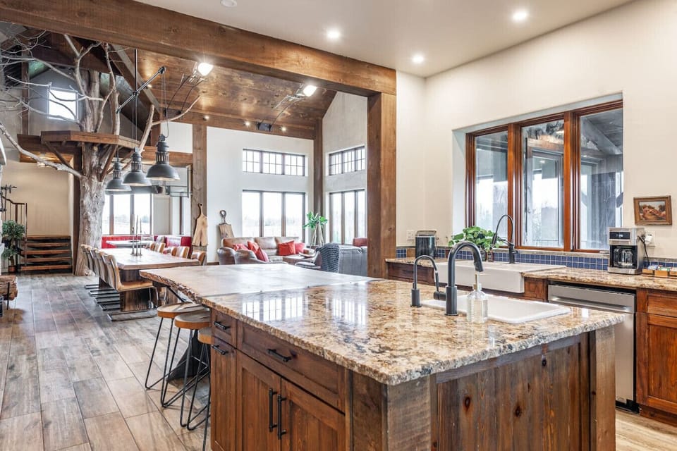 Fully equipped kitchen with large island, premium appliances, and seating for 20+ — great for group meals and events.