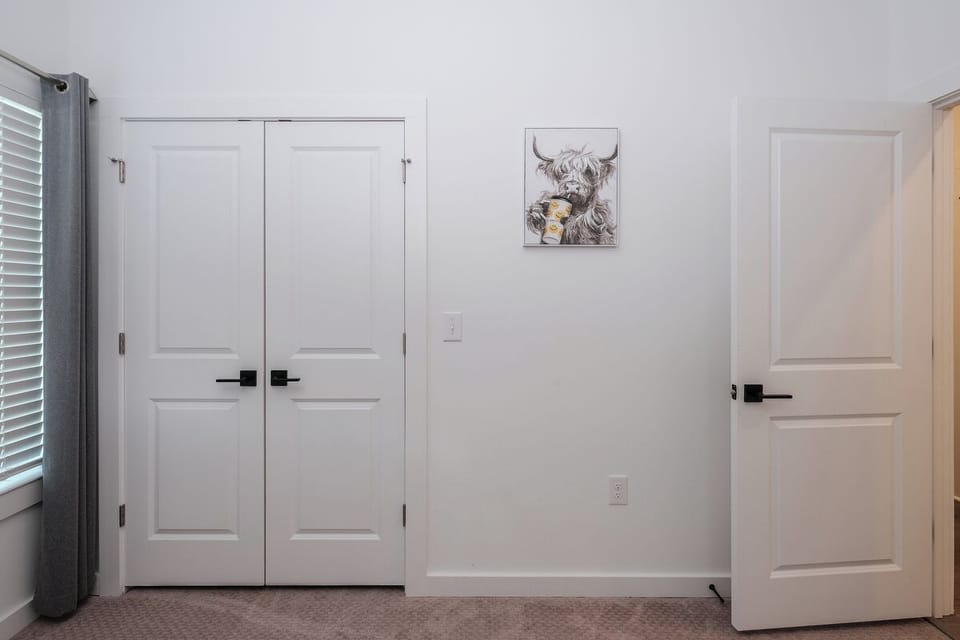 Bedroom 2 with two full beds & playful cow décor