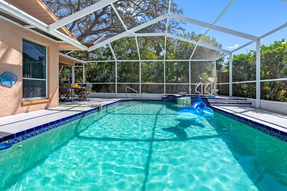 Enjoy the best of outdoor living with our beautiful screened-in pool and patio area, designed to let you soak up the Florida sunshine while staying cool, comfortable, and protected.