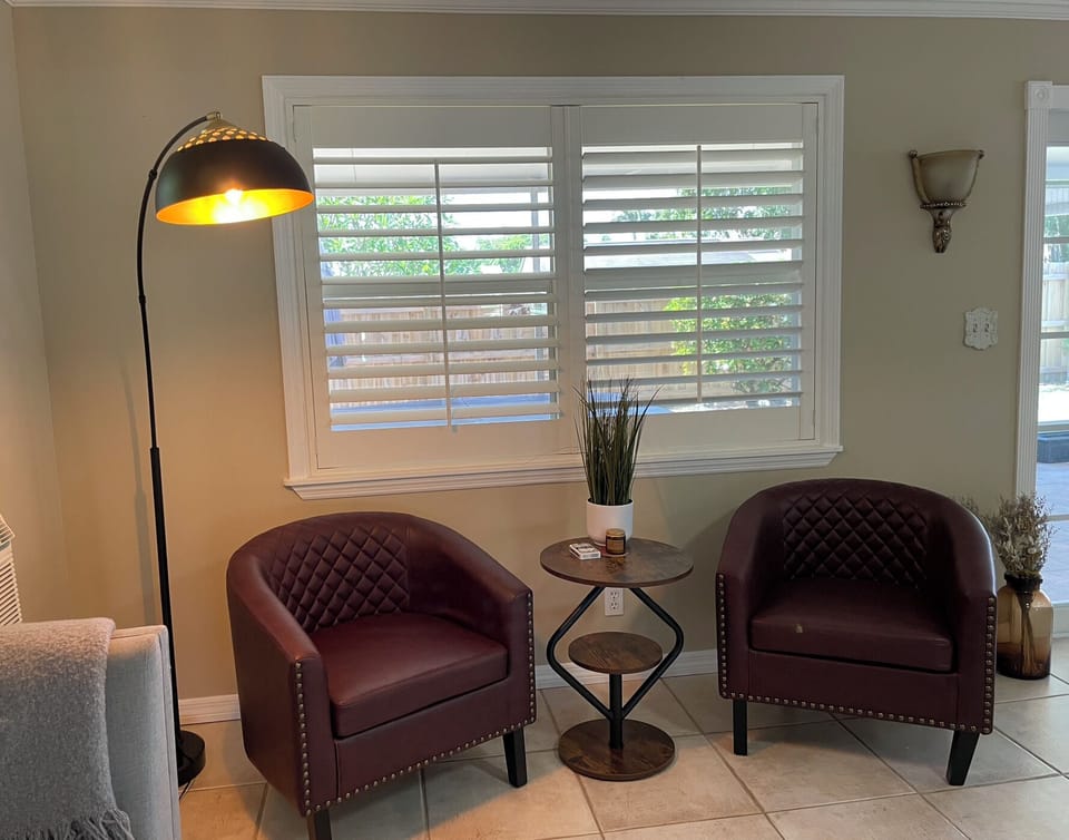 Our expansive rear living room has an abundance of seating and cozy nooks, as well as a comfortable couch with recliners.