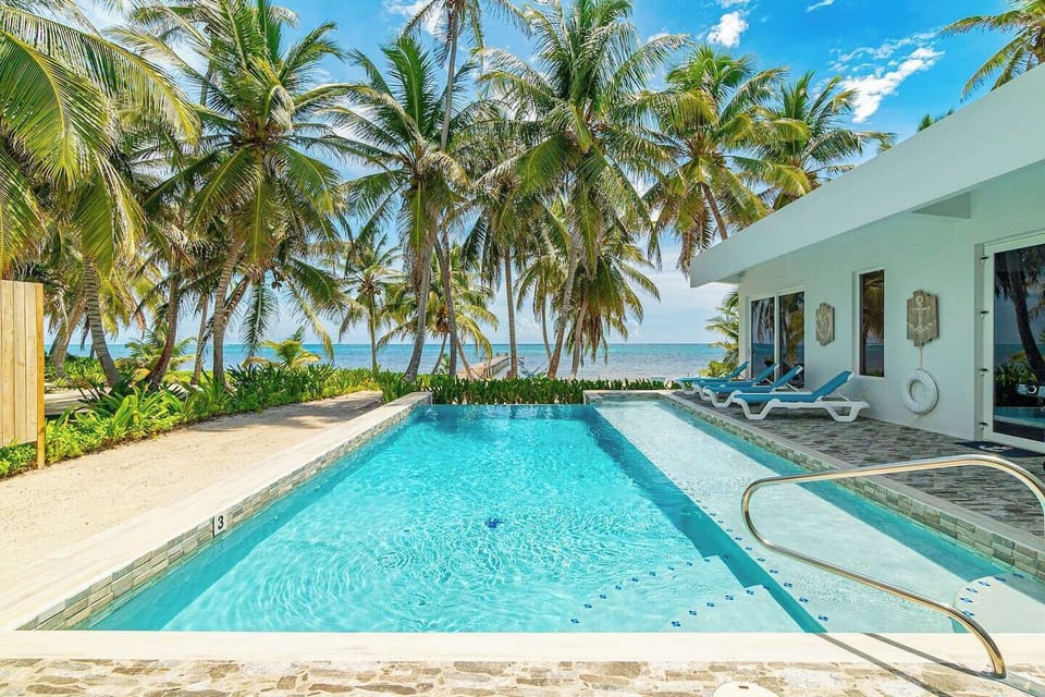 Private Oceanfront Pool Surrounded by Swaying Palms & Barefoot Luxury
