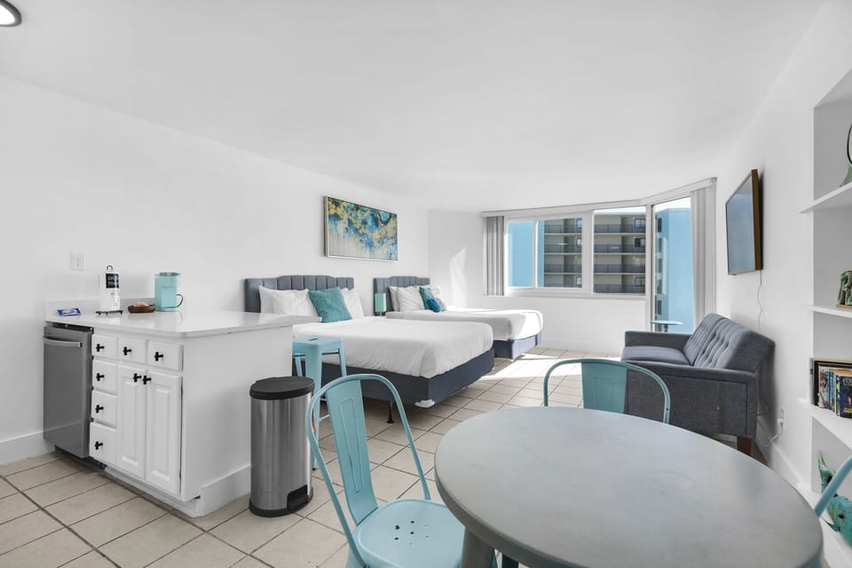Photo of room, 2 qheen beds, table, sofa