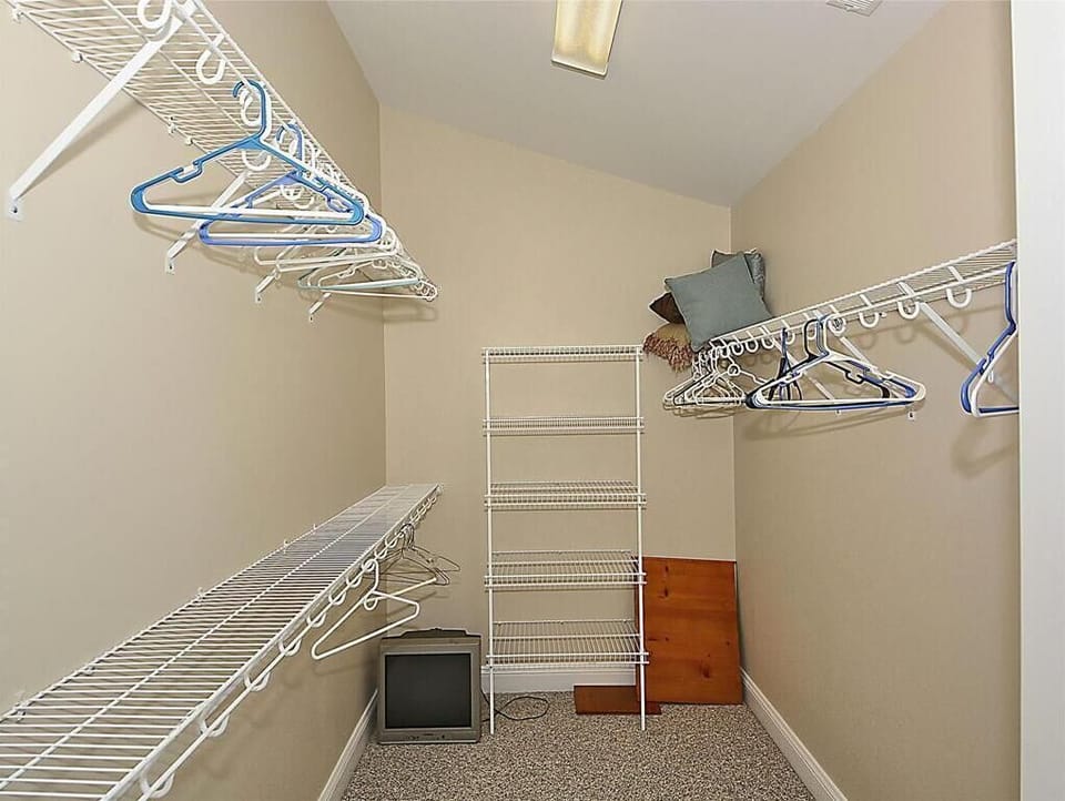 Experience the convenience of spacious organization in this expansive closet, designed to keep your beach gear neatly stored within easy reach.